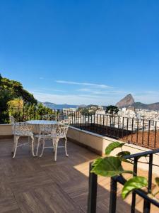 a table and chairs on a balcony with a view at New Sugar Loft Apartments in Rio de Janeiro