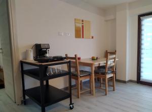 a kitchen with a table with chairs and a coffee maker at Casa Doris in Montabone