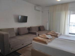 a living room with a bed and a couch at Hotel Villa Matic in Neum
