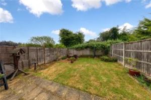 a fenced in yard with a fence at Entire 3 bedroom house in Luton +2 photos