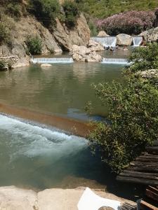 a body of water with a bench in front of it at مخيم اقشور in Chefchaouen