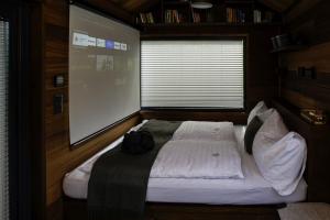 a bed in a room with a large window at Gradmina Glamping Retreat in Prevala