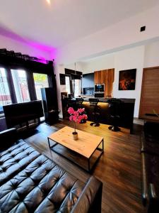 a living room with a couch and a coffee table at Chambre privée dans une maison d'hote in Liège