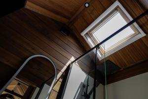 a glass staircase in a room with a window at Gradmina Glamping Retreat in Prevala +30 photos