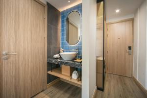 a bathroom with a sink and a mirror at MAY DE VILLE Prestige Hotel in Hanoi +66 photos