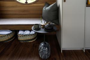 a room with a table with a bench and a window at Gradmina Glamping Retreat in Prevala