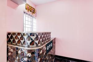 a room with a bunch of tiles on the wall at Hotel O KSR GRAND in Maula Ali