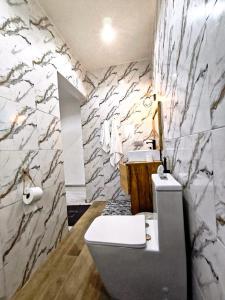 a bathroom with two sinks and a toilet and a counter at Luxe villa 3 chambres Somone in Somone +12 photos