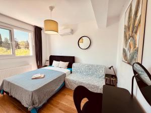 a bedroom with two beds and a table and a mirror at The Blue House in Larnaca +96 photos