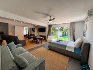 a bedroom with a bed and a couch and a living room at The Blue House in Larnaca