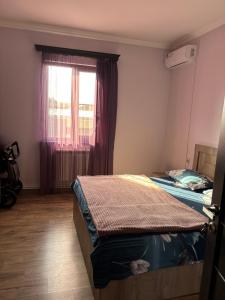 a bedroom with two beds and a window at New , comfortable 3 bedroom house in Yerevan