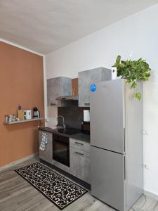 a kitchen with a white refrigerator and a kitchen rug at Isabel House in Capoterra