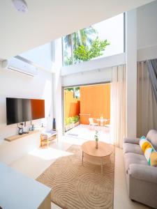 a living room with a couch and a table at The Samui Villa Retreat in Ban Bang Po