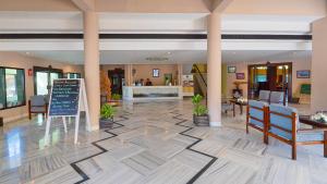 a lobby with chairs and a sign on the floor at Indo Asia Heritage, Madikeri, formerly Hotel Coorg International in Madikeri +68 photos