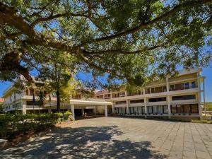 an office building with a tree in front of it at Indo Asia Heritage, Madikeri, formerly Hotel Coorg International in Madikeri