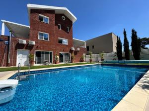 a large swimming pool in front of a building at The Blue House in Larnaca