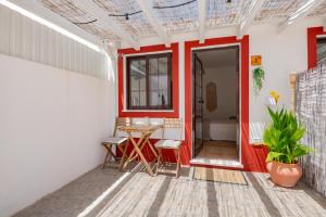 a room with a red door and a table at Brisa de Milfontes in Vila Nova de Milfontes +13 photos