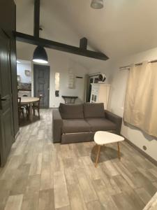 a living room with a couch and a table at Gilie beach in Saint-Brevin-les-Pins