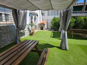 a garden with a wooden bench and a tent at Lavanda Natur León3 Apartment 5 Pers in Villafañé