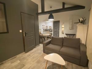 a living room with a couch and a table at Gilie beach in Saint-Brevin-les-Pins