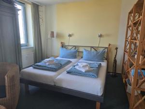 a bedroom with two beds with towels on them at Fehmarn- Ostseeferien FeWo Prusseit 171 in Fehmarn