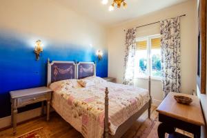 a bedroom with a bed and a blue wall at Luxury Residence Zadar in Zadar