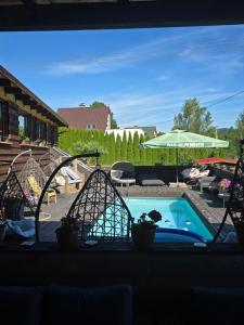 a view from a window of a swimming pool at Wellness-Beskydy in Prostřední Bečva