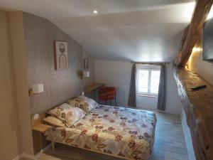 a small bedroom with a bed and a window at Le sabot de Madame in Lussac-les-Châteaux