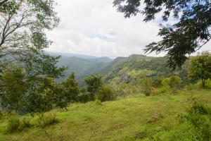 a view of a valley with mountains in the background at BASIS Mountain House in Thekkady +12 photos