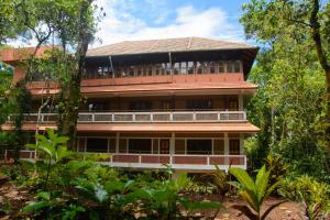 a large building in the middle of a forest at BASIS Mountain House in Thekkady