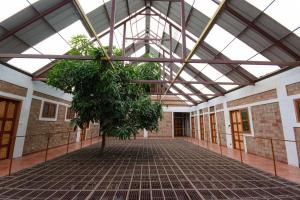 a building with a tree in the middle of a hallway at BASIS Mountain House in Thekkady