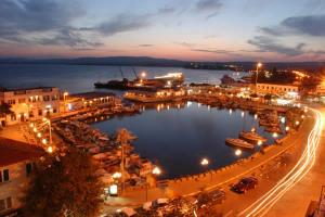 a city with a marina at night with cars parked at Go to Sleep in Gelibolu