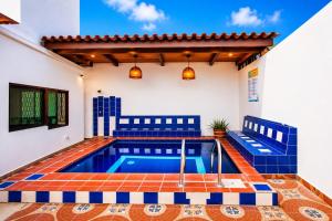 a pool in a house with blue and white tiles at La Villa de Sofia in Santa Marta