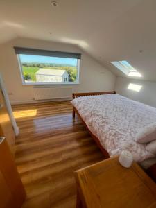 a bedroom with a bed and a large window at Hackettstown in Ardmore +7 photos