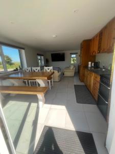 a kitchen and living room with a table and a couch at Hackettstown in Ardmore