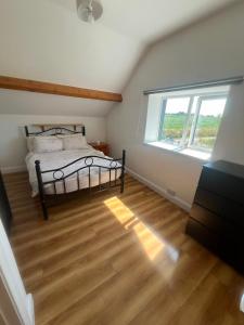 a bedroom with a bed and a large window at Hackettstown in Ardmore