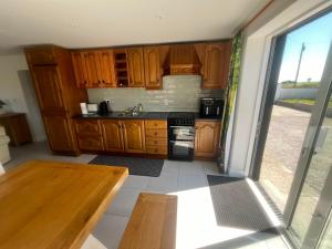 a kitchen with wooden cabinets and a wooden table at Hackettstown in Ardmore