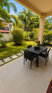 a black table and chairs on a patio at The Garden, Miami Lakes in Miami Lakes
