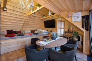 a living room with a table and chairs and a couch at Wellness-Beskydy in Prostřední Bečva