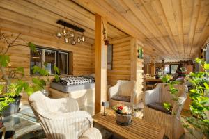 a patio with chairs and a table and a bench at Wellness-Beskydy in Prostřední Bečva