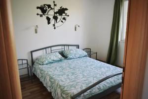 a bedroom with a bed with a blue comforter at Agava in Lovište