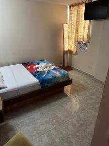 a bedroom with a dog laying on a bed at Cid Hotel Mérida in Mérida