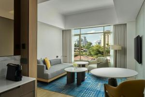 a living room with a couch and a table at Petaling Jaya Marriott Hotel in Petaling Jaya