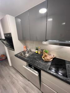 a kitchen with a sink and a stove at Romarin in Marin