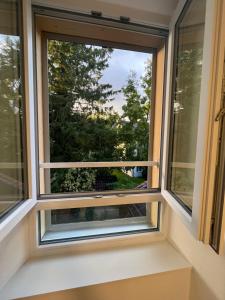 a window with a view of a tree at Romarin in Marin
