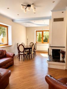 a living room with a table and chairs and a fireplace at Flower 18 in Jūrmala