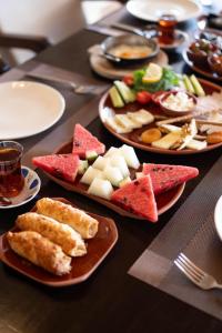 a table with plates of food on it at La Fairy Cappadocia in Uçhisar
