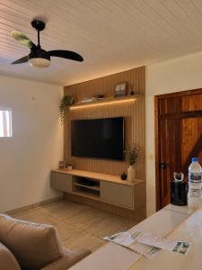a living room with a flat screen tv on a wall at KmX in Campo Grande