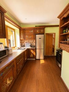 a kitchen with wooden cabinets and a stainless steel refrigerator at Flower 18 in Jūrmala