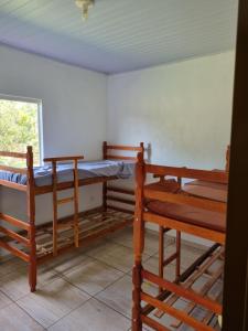 a room with two bunk beds and a window at KmX in Campo Grande +3 photos
